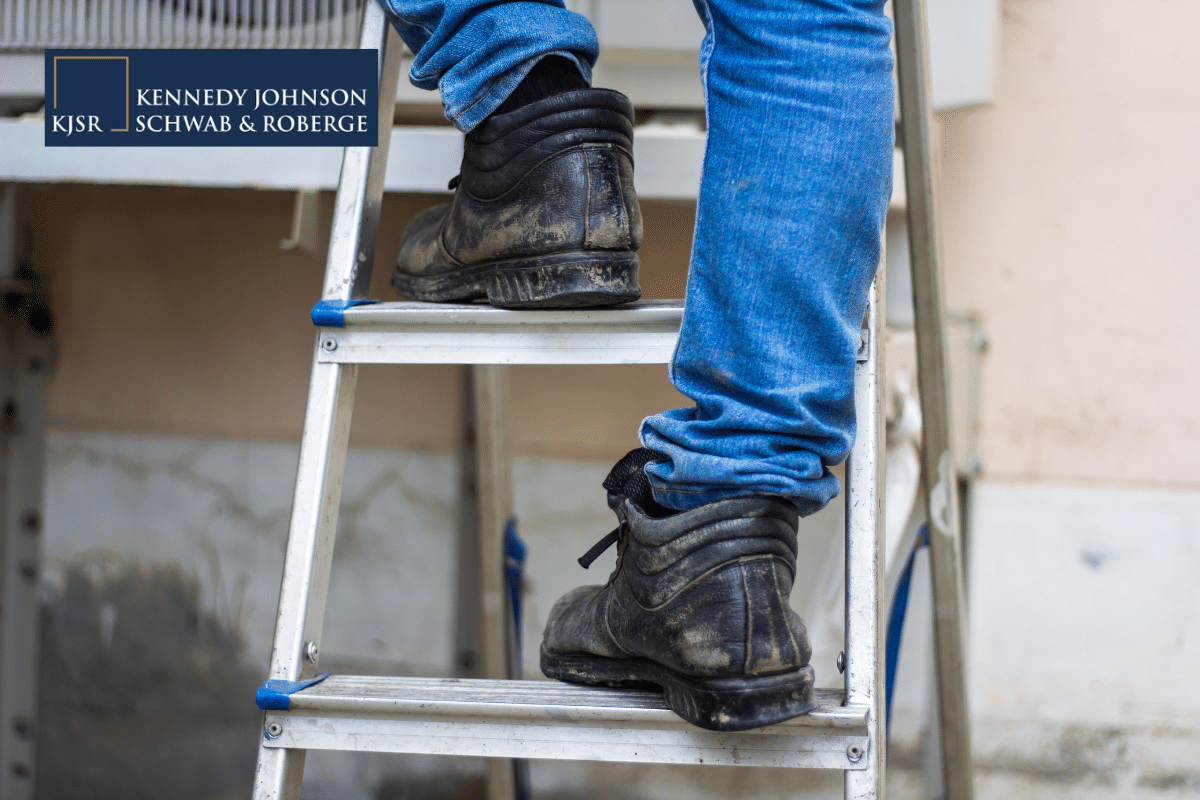 Worker climbing ladder