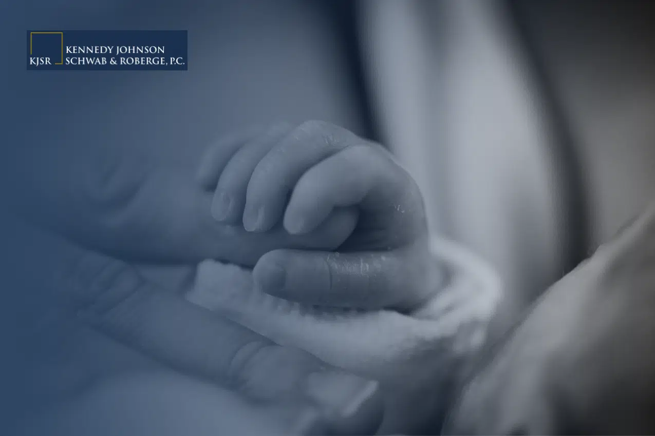 Newborn holding mother's hand